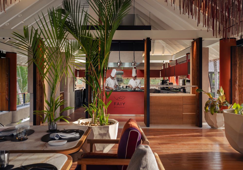 chefs working in luxury wellness restaurant with palm leaves