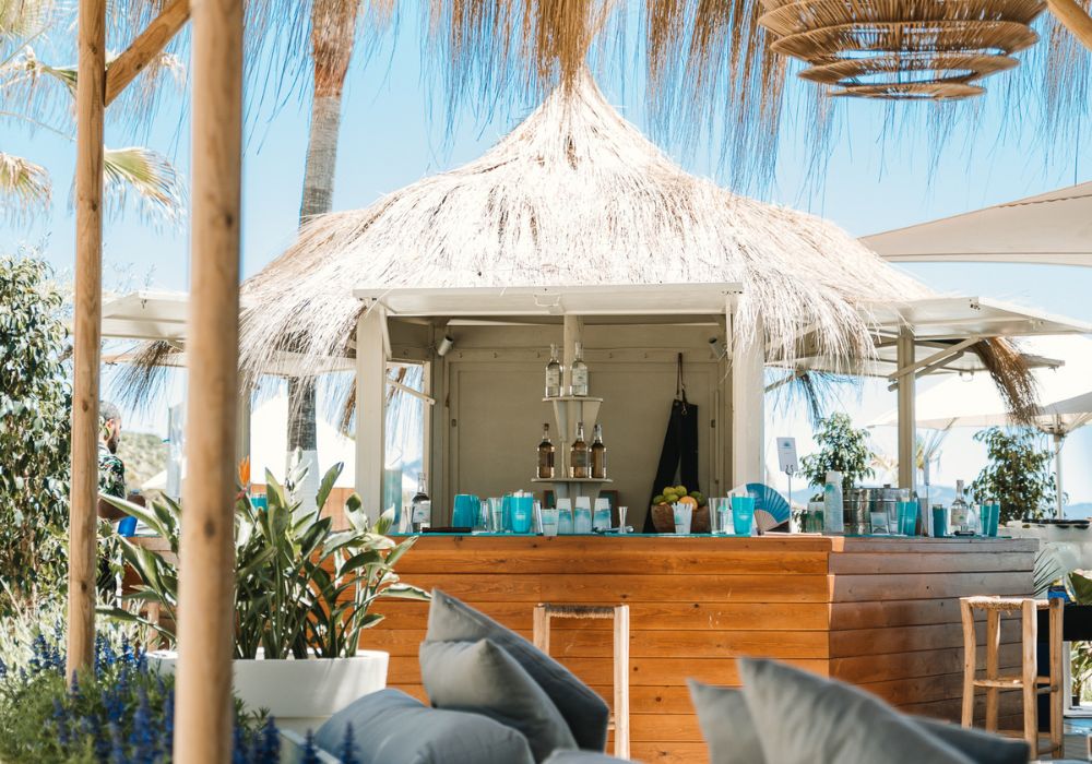 luxury beach hotel with bar and drinks surrounded by palm trees