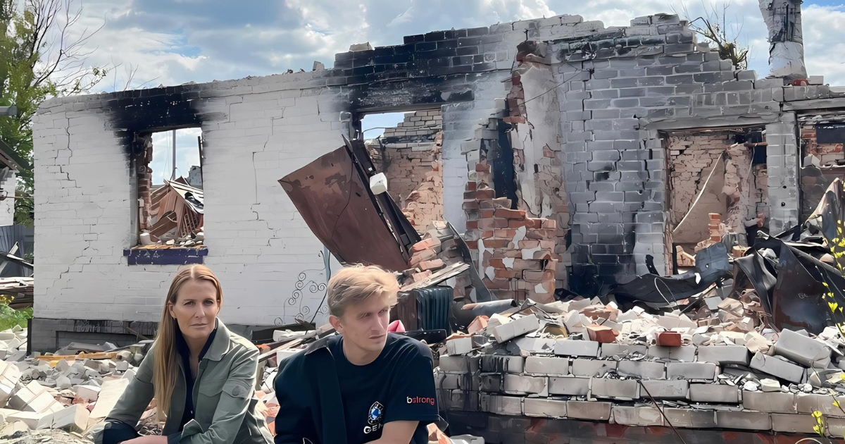 India and her son sit pensively amidst the ruins of a bombed-down building in Ukraine, with their expressions reflecting the somber reality of devastation and loss.